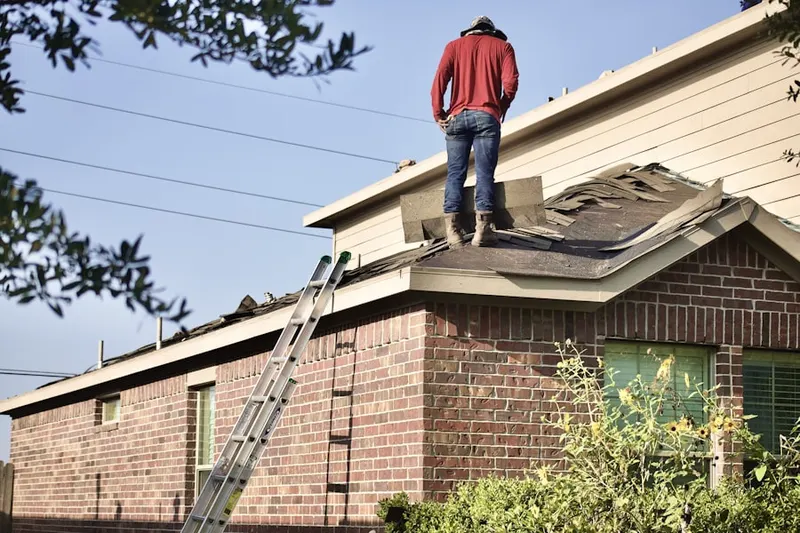 Professional roofer working on a residential roof in San Remo